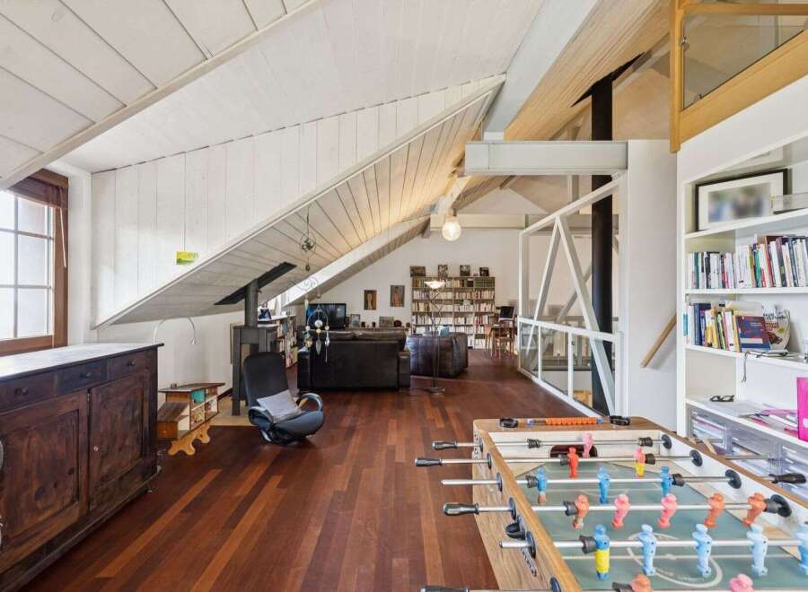 This stunning loft boasts a unique architectural design with exposed beams and a spacious layout.