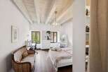 This charming bedroom boasts a unique blend of rustic and elegant design elements.
