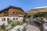 Enjoy the tranquility of this stunning property featuring a spacious wooden deck, perfect for outdoor gatherings.