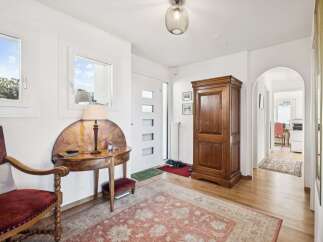 Step into this inviting entryway, showcasing a blend of classic charm and modern design.