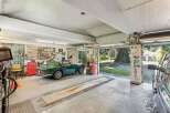 Step into this stunning garage, a haven for car enthusiasts and collectors alike.