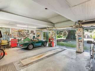 Step into this stunning garage, a haven for car enthusiasts and collectors alike.
