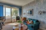 This charming living room offers stunning views and a cozy atmosphere.