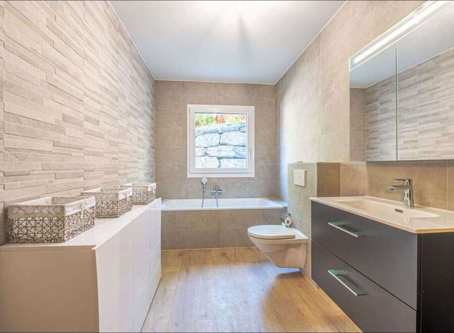 Step into a modern bathroom oasis! This beautifully designed space features a sleek vanity with ample storage, perfect for keeping your essentials organized.