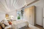 Discover the charm of this inviting bedroom, featuring a cozy bed and ample storage.