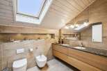 This stunning bathroom boasts a modern design with a touch of natural elements.