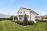 Discover the charm of this stunning modern home, boasting a pristine white exterior and a beautifully landscaped yard.