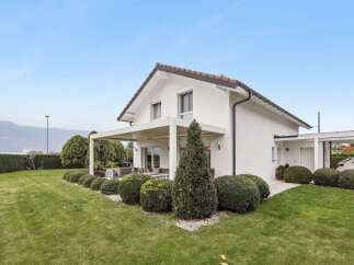 Discover the charm of this stunning modern home, boasting a pristine white exterior and a beautifully landscaped yard.