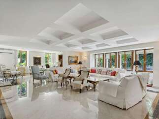Step into luxury with this stunning living room, featuring a bright and airy design.