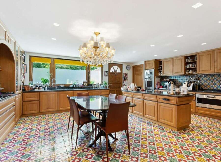 Step into luxury with this stunning kitchen! Featuring a spacious layout, elegant chandelier, and beautiful tile flooring, this kitchen is perfect for both cooking and entertaining.