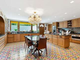 Step into luxury with this stunning kitchen! Featuring a spacious layout, elegant chandelier, and beautiful tile flooring, this kitchen is perfect for both cooking and entertaining.