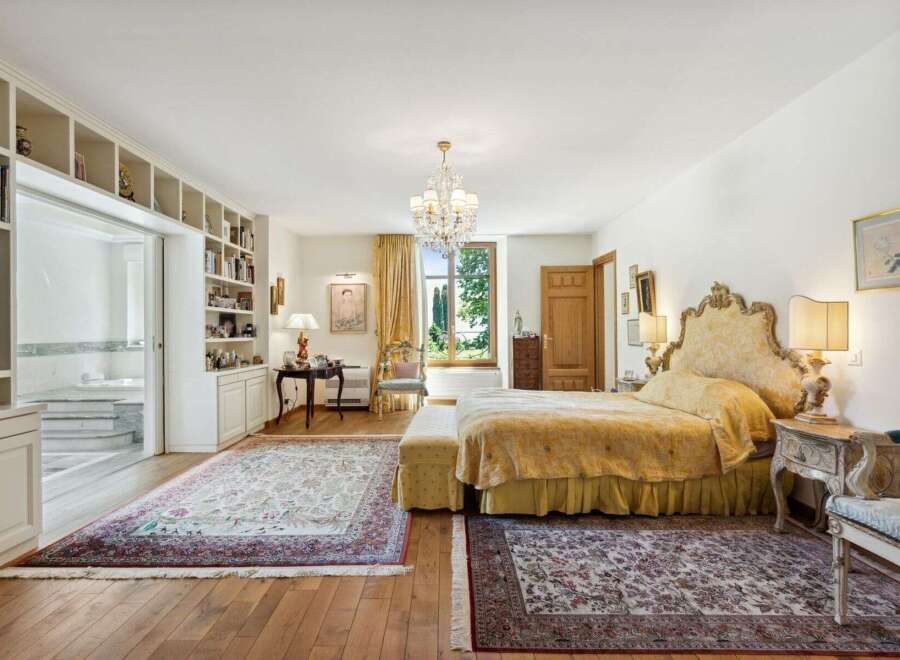 Step into luxury with this exquisite bedroom, boasting a grand, ornate bed and elegant furnishings.