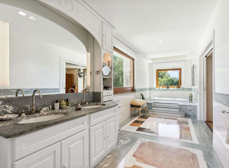 Indulge in luxury within this stunning bathroom, featuring a double vanity with elegant fixtures and ample storage.