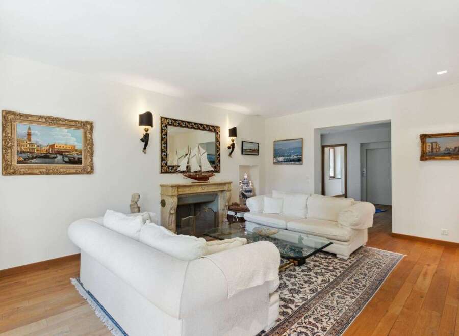 Step into luxury with this stunning living room, featuring a cozy fireplace and elegant decor.