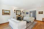 Step into luxury with this stunning living room, featuring a cozy fireplace and elegant decor.