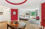 Step into luxury with this stunning bedroom featuring a unique red accent wall and elegant design.