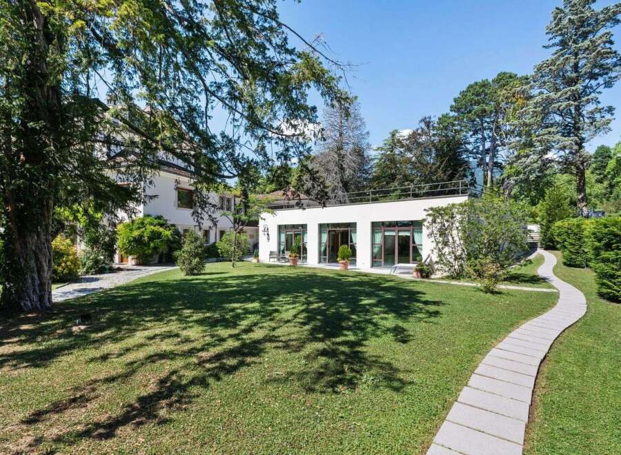 Discover a stunning property with a beautifully manicured lawn and a modern architectural design.