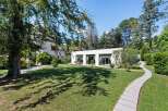 Discover a stunning property with a beautifully manicured lawn and a modern architectural design.