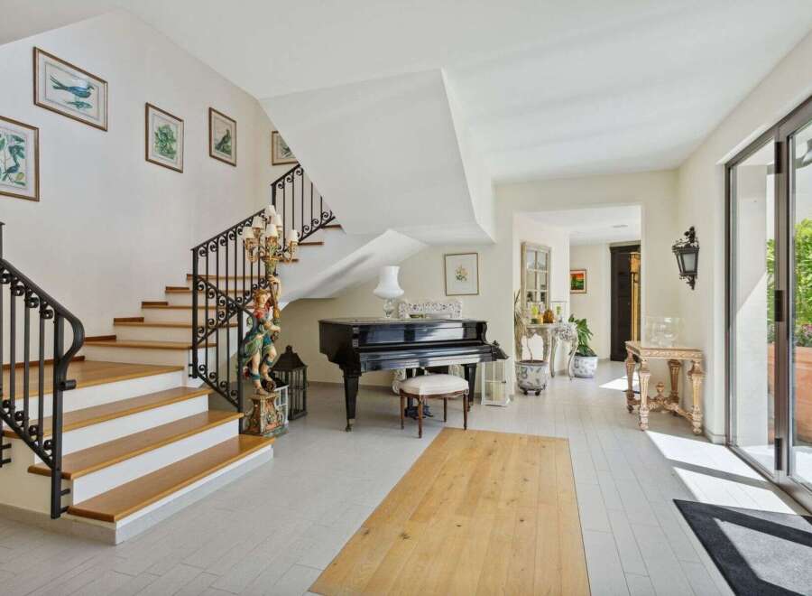 Step into luxury with this stunning property featuring a grand staircase and elegant design.