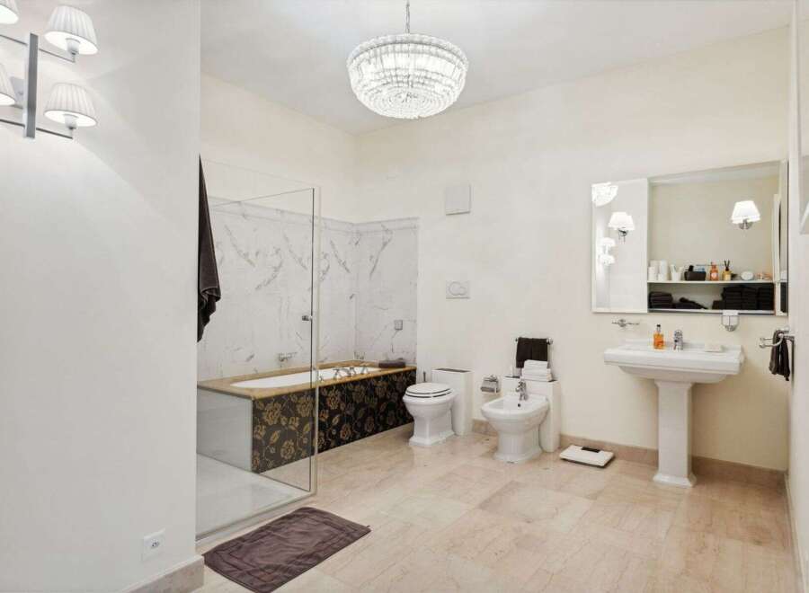 Step into luxury with this stunning bathroom! Featuring a beautiful chandelier, elegant fixtures, and a spacious layout, this bathroom is designed for relaxation and comfort.