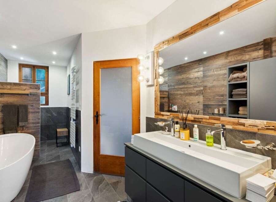 Step into luxury with this stunning bathroom featuring a modern design and rustic accents.