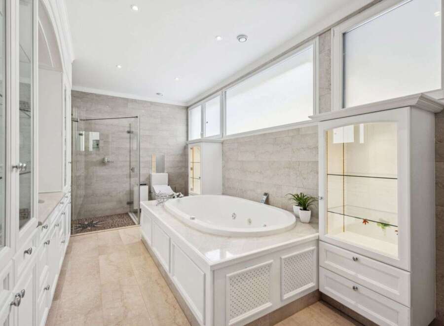 Indulge in luxury within this stunning bathroom, featuring a sleek, modern design.