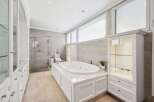 Indulge in luxury within this stunning bathroom, featuring a sleek, modern design.