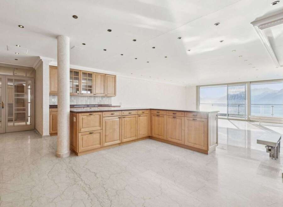 Experience luxury living in this stunning property featuring a modern kitchen with ample storage and a sleek design.