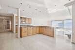 Experience luxury living in this stunning property featuring a modern kitchen with ample storage and a sleek design.