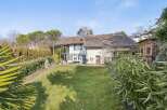 Discover this charming property featuring a spacious lawn and a well-maintained exterior.