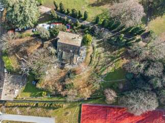 Discover this stunning property featuring a charming house nestled amidst lush greenery.
