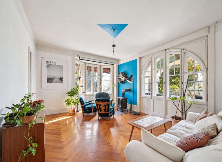 Step into this inviting living room, bathed in natural light streaming through large windows.