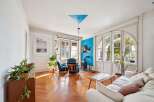 Step into this inviting living room, bathed in natural light streaming through large windows.