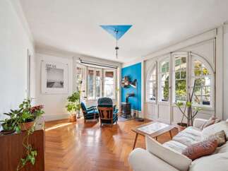 Step into this inviting living room, bathed in natural light streaming through large windows.