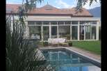 Discover luxury living in this stunning property featuring a beautiful pool and a modern sunroom.
