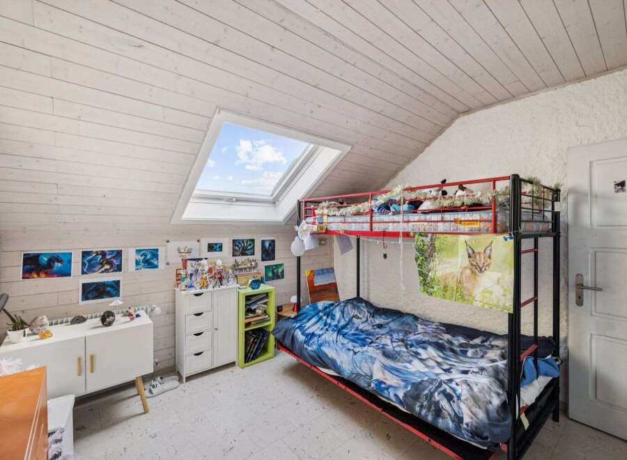 Discover this charming bedroom featuring a unique bunk bed design, perfect for maximizing space.