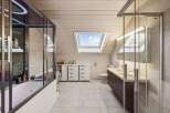 This stunning bathroom boasts a modern design with a luxurious feel.