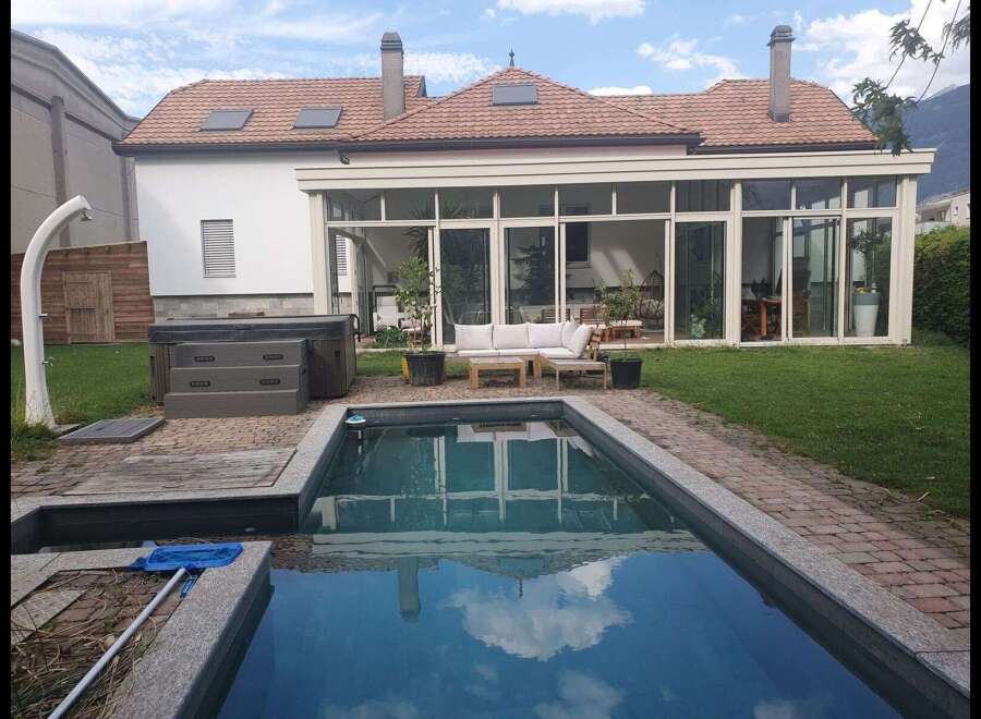 Discover luxury living with this stunning property featuring a private pool and a relaxing hot tub.