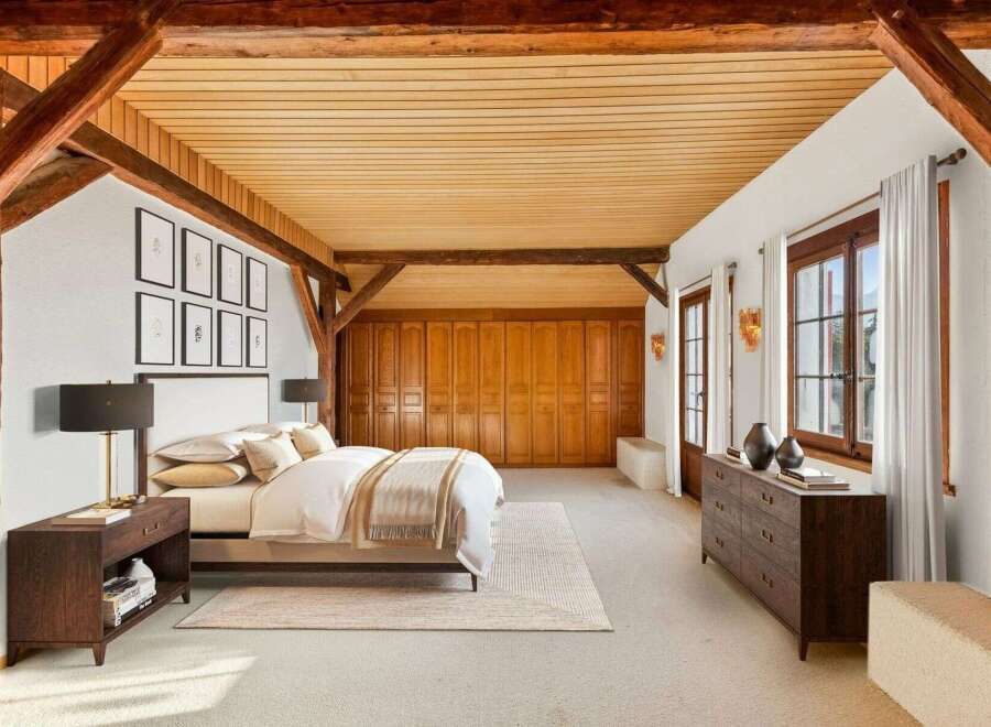 This stunning bedroom showcases rustic charm with exposed wooden beams and a warm, inviting ambiance.