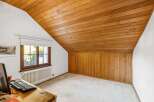 Discover the charm of this inviting room, featuring a warm wooden ceiling and paneling that adds character and style.