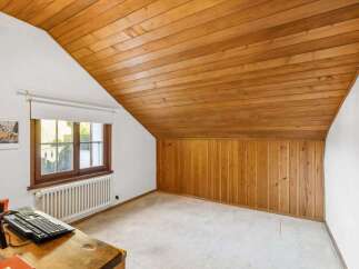 Discover the charm of this inviting room, featuring a warm wooden ceiling and paneling that adds character and style.