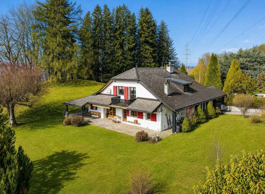 Nestled amidst lush greenery and mature trees, this charming property offers a serene retreat with picturesque views.