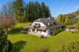Nestled amidst lush greenery and mature trees, this charming property offers a serene retreat with picturesque views.