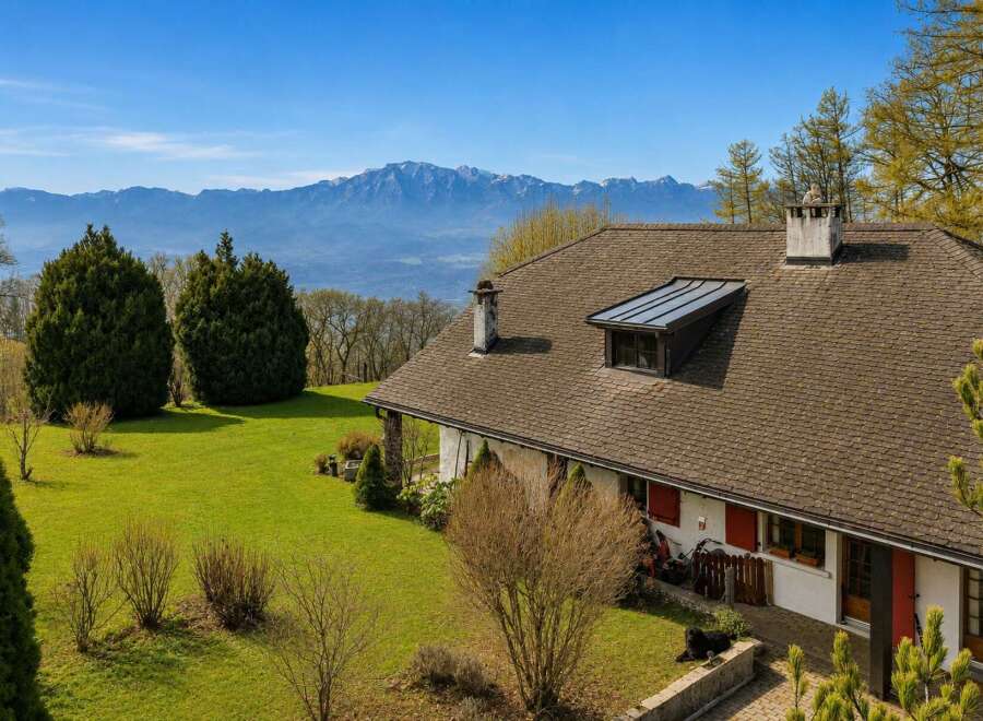 Experience breathtaking panoramic views from this charming property, nestled amidst lush green lawns and mature trees.