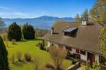 Experience breathtaking panoramic views from this charming property, nestled amidst lush green lawns and mature trees.