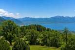 Experience breathtaking panoramic views of a serene lake and majestic mountains from this stunning property.