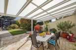 Enjoy outdoor living at its finest with this stunning property featuring a covered patio, perfect for entertaining or relaxing.