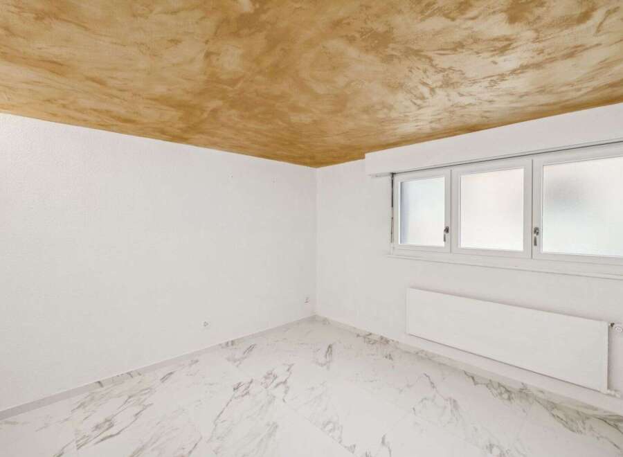 Discover this bright and airy room, featuring a unique textured ceiling that adds character.