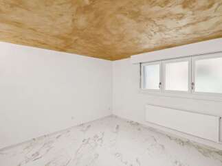 Discover this bright and airy room, featuring a unique textured ceiling that adds character.