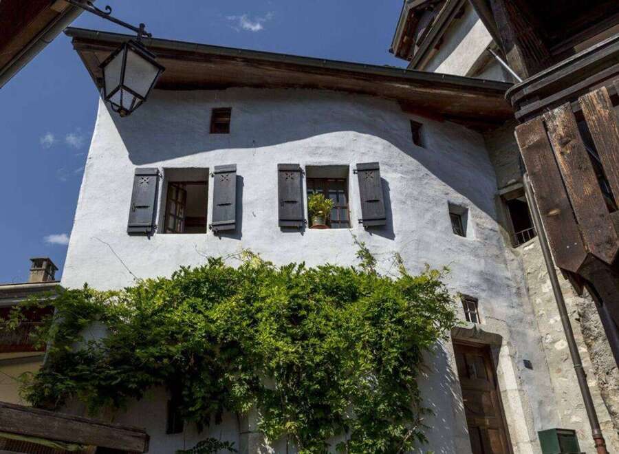 Discover the charm of this historic property, featuring a unique architectural design with traditional shutters and windows.